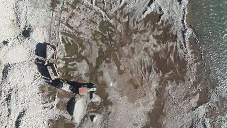 machines working in the riverbed descending from the andes mountains