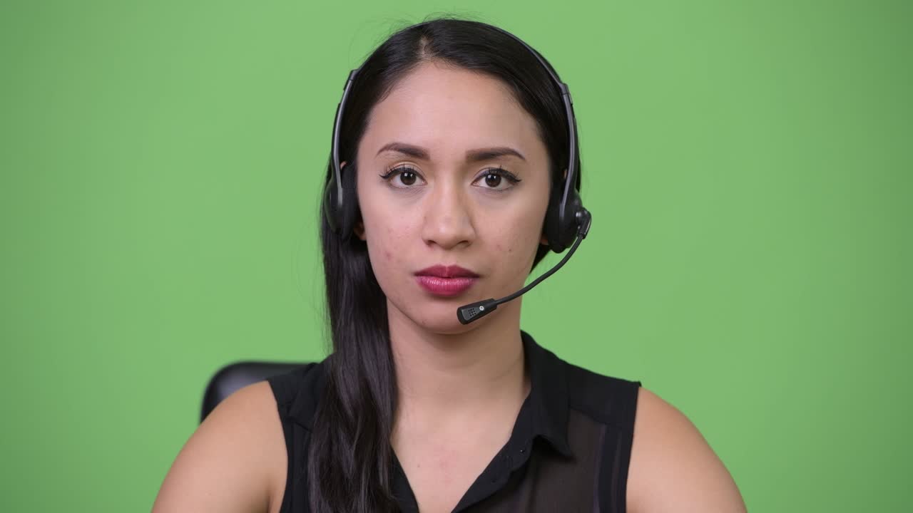 Young beautiful Asian businesswoman as call center representative