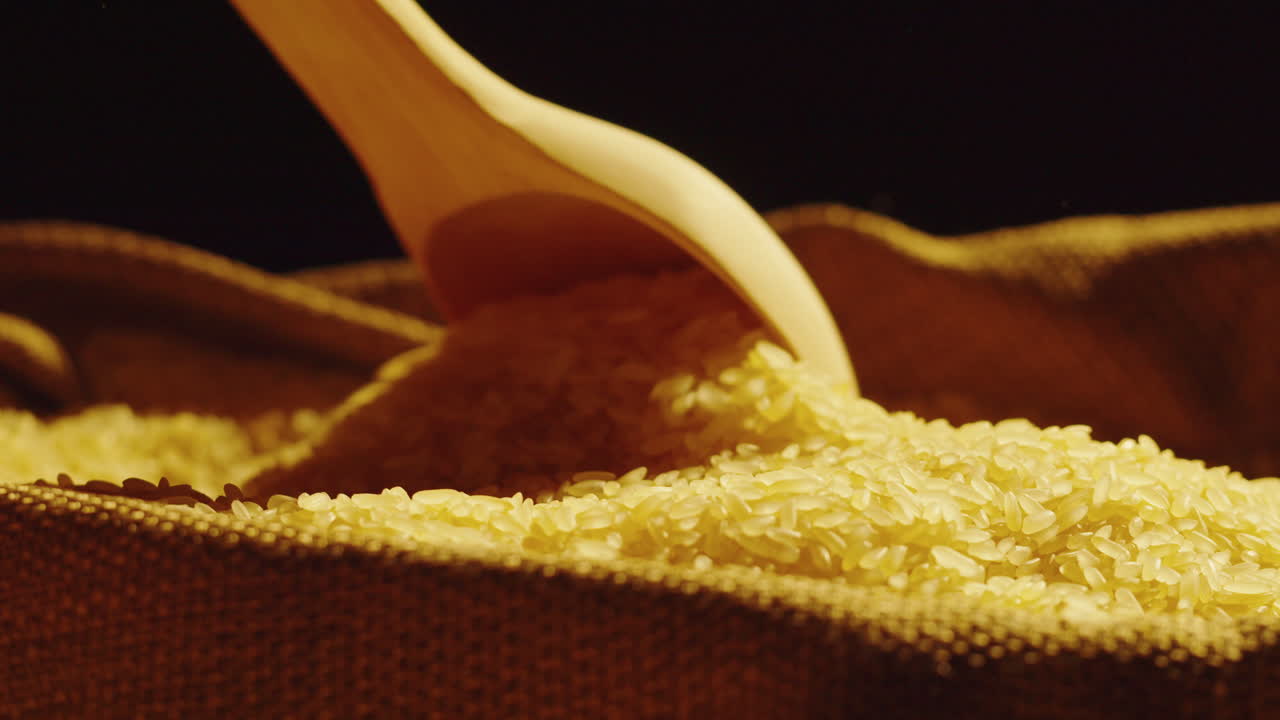 Scooping and Pouring Raw Rice Grains