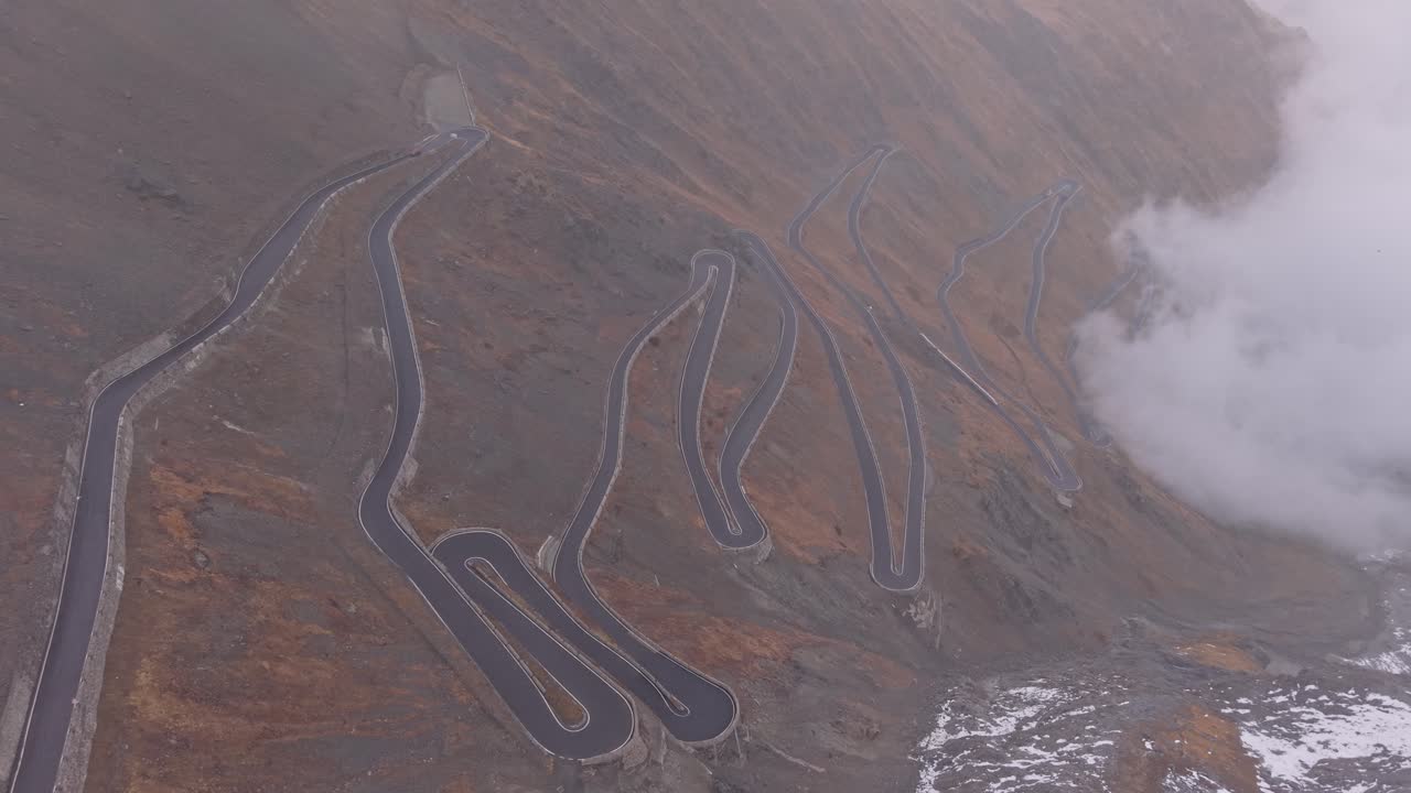 Stelvio Pass hairpin bends from sky, scenic drive in the Alps