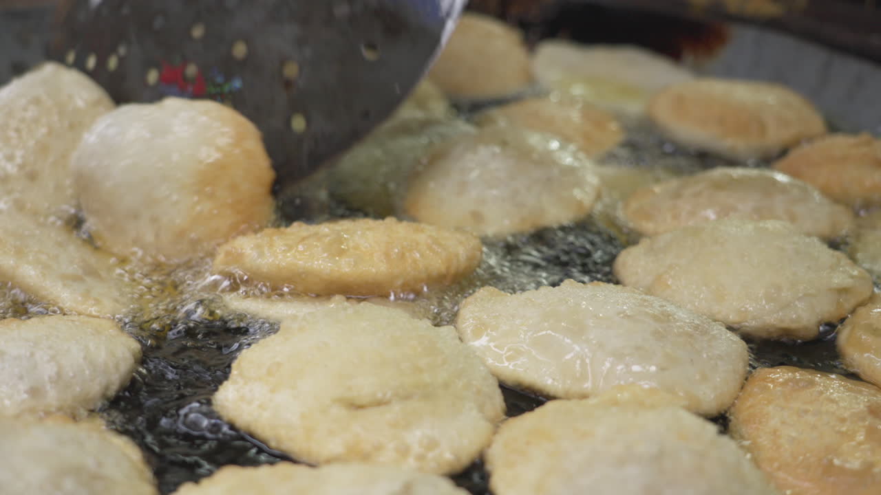 Puri frying in oil - Dhaka Bangladesh. Puri is an Indian and Bangladeshi deep-fried bread made from unleavened flour, typically served with curries or lentils, known for its crispy texture,