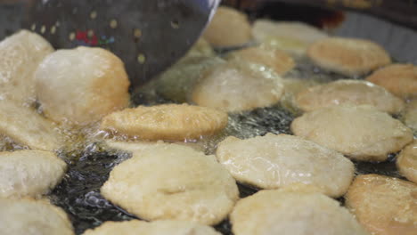 puri frying in oil - dhaka bangladesh. puri is an indian and bangladeshi deep-fried bread made from unleavened flour, typically served with curries or lentils, known for its crispy texture,
