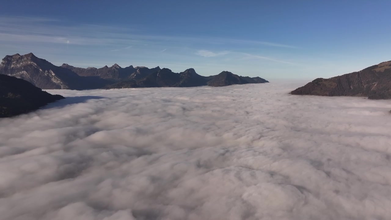Bird's-eye view of the famous Walensee Lake in Switzerland, shrouded in clouds at sunrise.