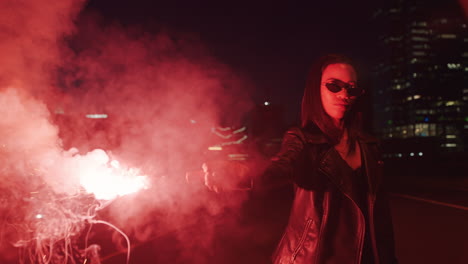 woman lighting signal flare in city at night rebellious girl protesting in street with firework