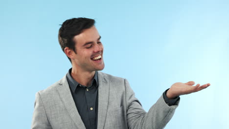 Smile,-pointing-and-young-businessman-in-studio