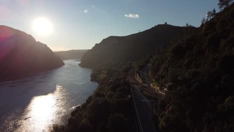 Aerial-view-of-Train-crossing-the-riverside-railroad-in-Vila-Velha-de-Ródão-Natural-Monument