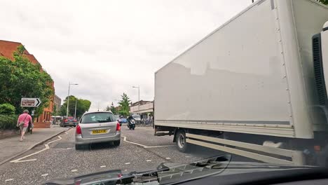 vehicles and people navigating a busy street