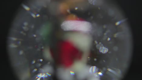 Spinning-Santa-Claus-Christmas-ball-background-defocused-snowing-twinkles-shine-and-move