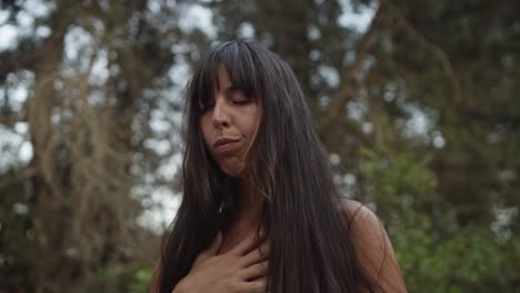 a woman in white dress is practicing mindfullness in the nature