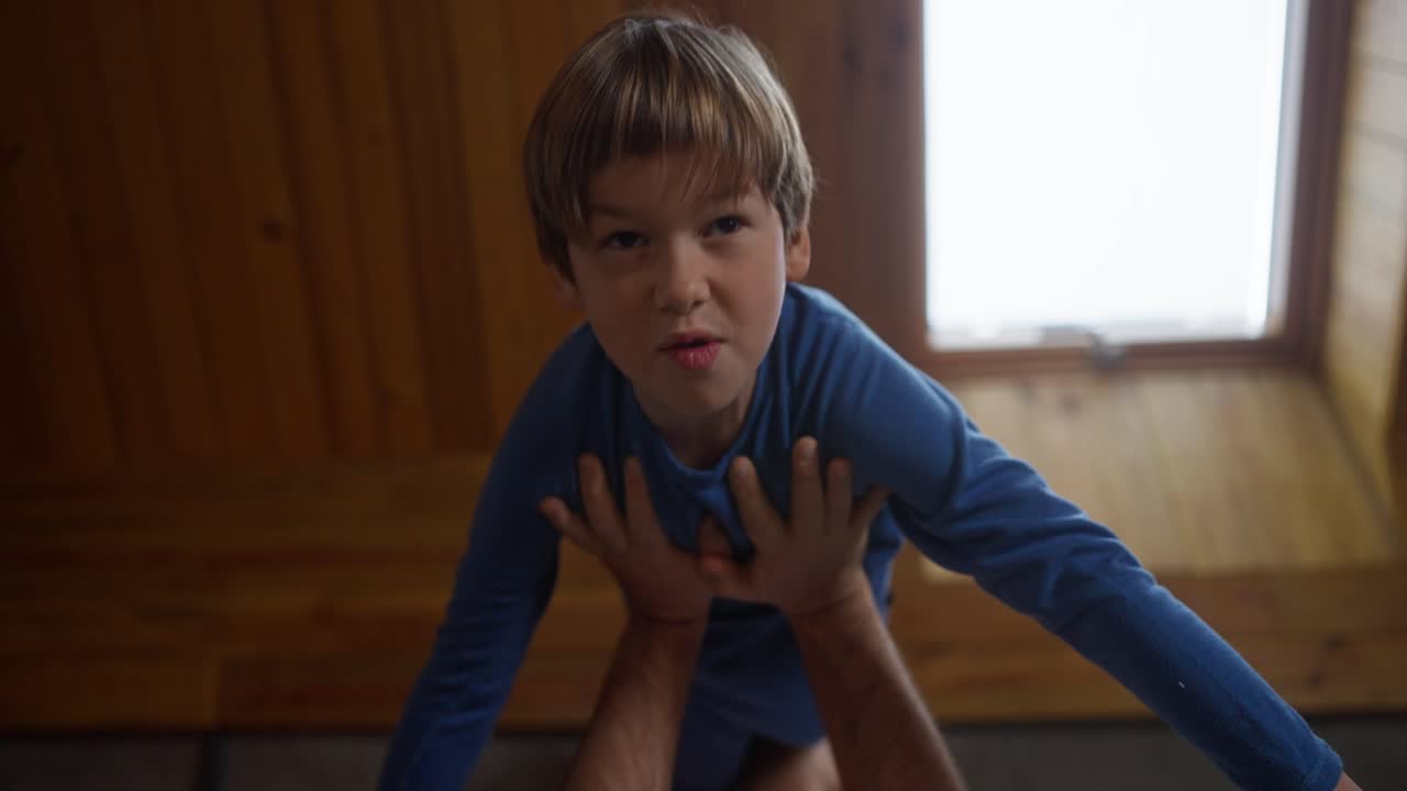 A boy being held up in the air
