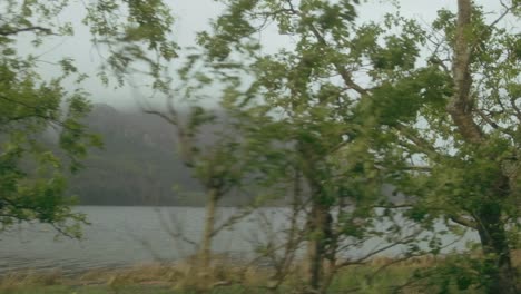 slow-motion drive along a misty mountain lake, uk