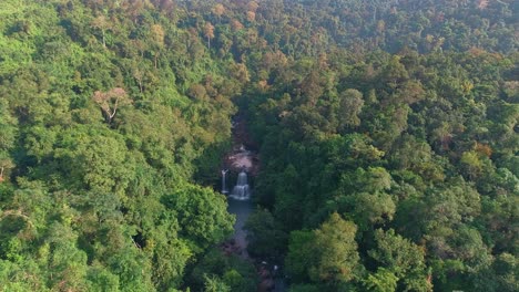 aerial view of a waterfall in a lush rainforest