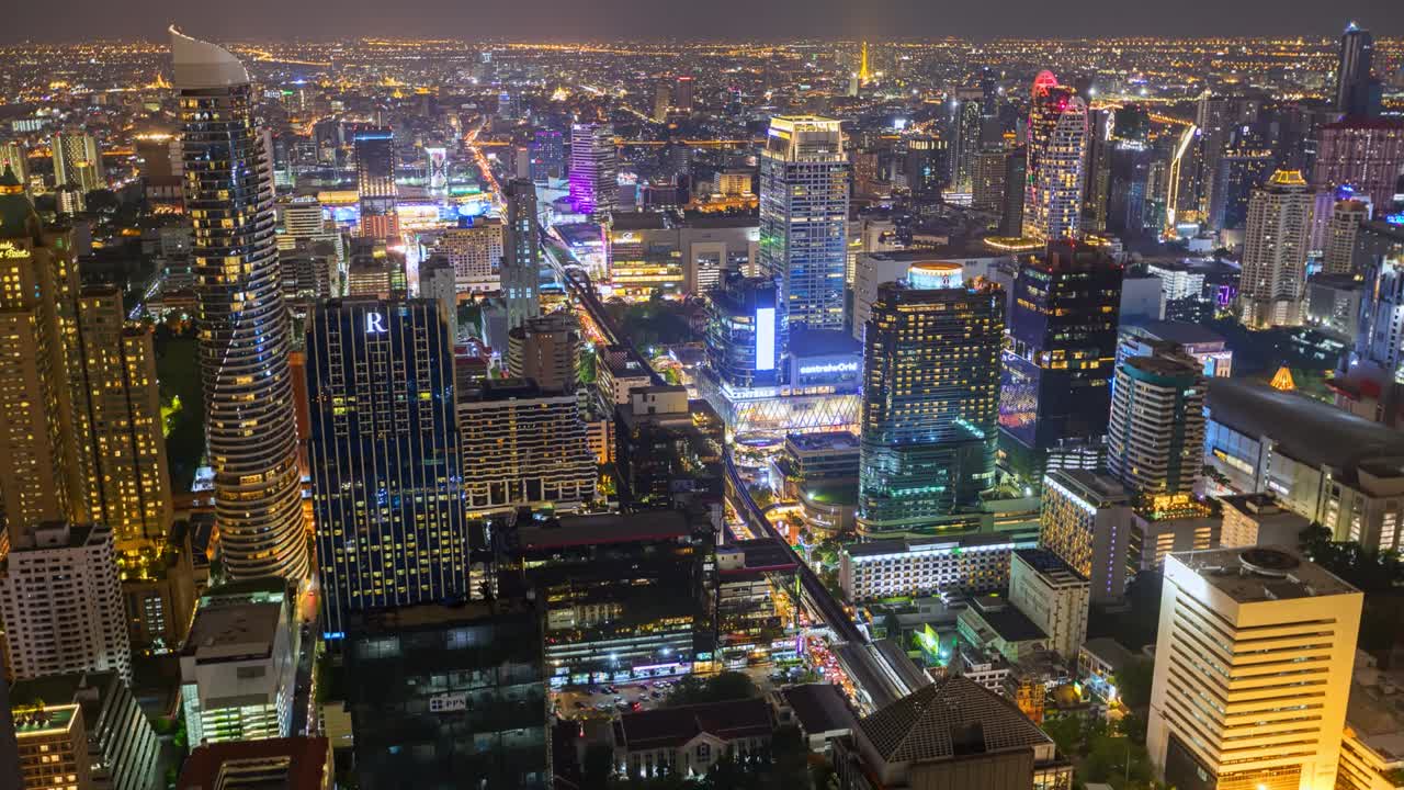 Aerial view of Ploenchit junction with cars traffic skyscraper buildings. Bangkok City in downtown at night, Thailand