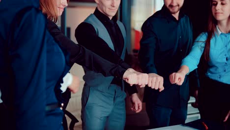 many hands, holding together in a modern office