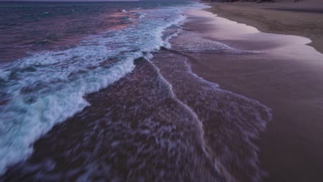 popping-up aerial view about the praia da lagoa coastline at evening, portugal