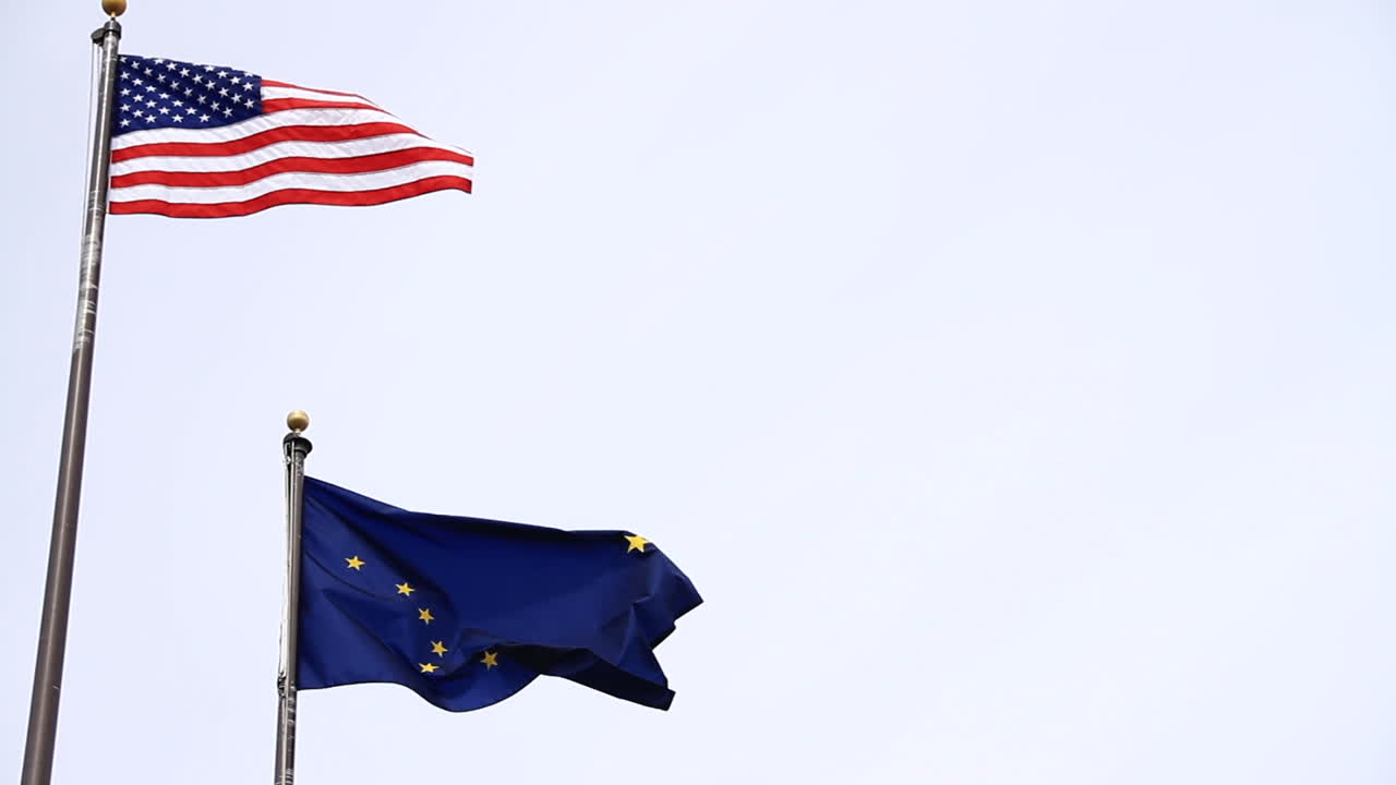 American and Alaska Flags Wave in Wind