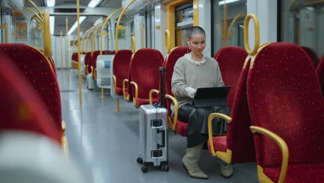 woman working on tablet in subway