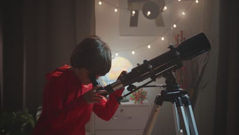 a young boy looks through his telescope at the night sky and then looks up with a smile of pure wonder and joy. a concept of childhood discovery, science, and education