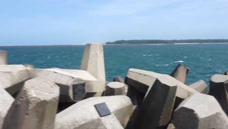 Dolly-shot-of-dolos-pier-with-the-sea-in-the-background