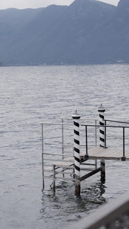 lake pier with striped poles