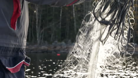 fisherman working with fishing net or fishnet, close up