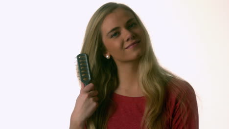 pretty blonde brushing her hair