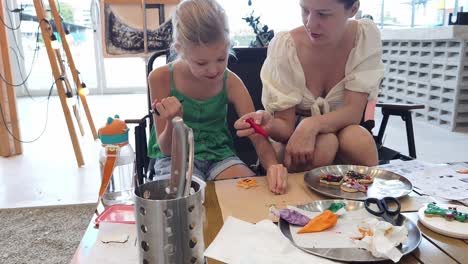 mother and daughter decorating cookies