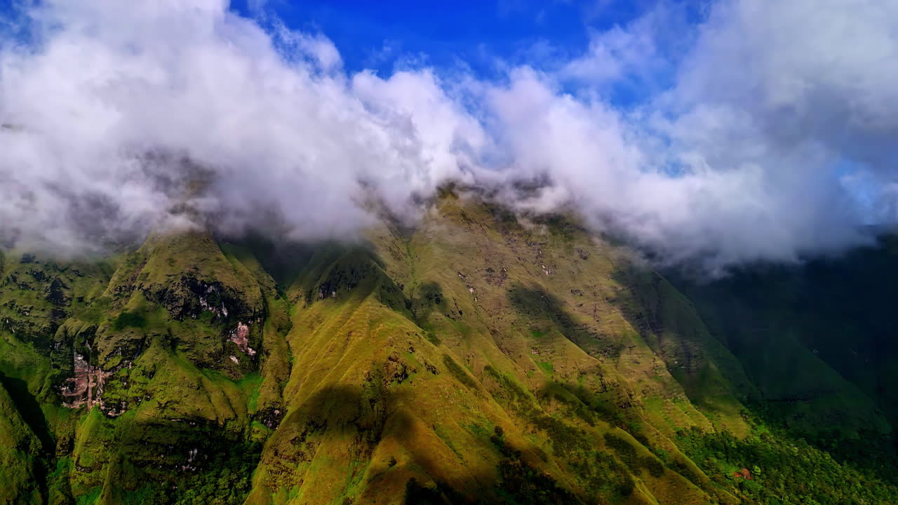 Misty green hills under clouds at Bukit Selong, Bali with tropical morning light
