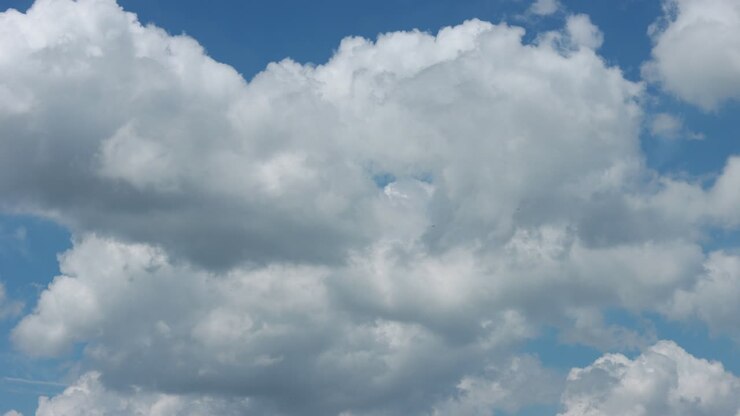 Timelapse of white clouds on blue sky.