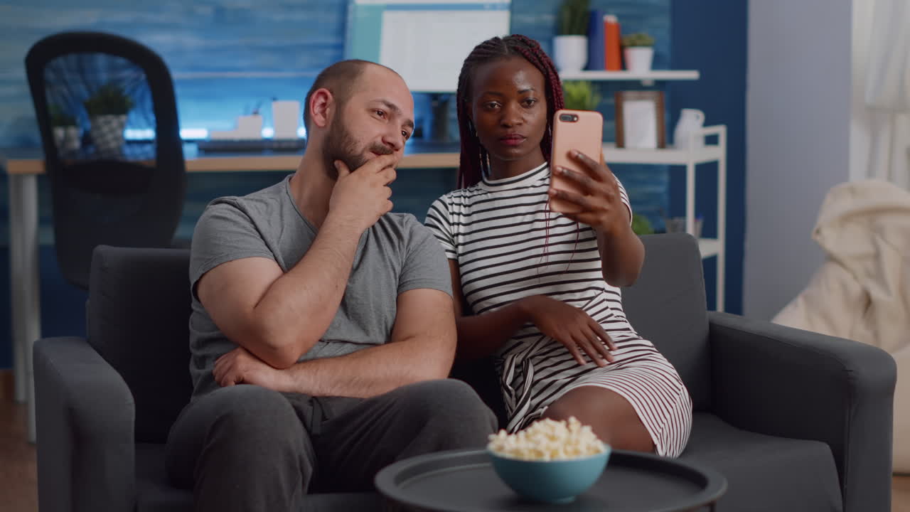 Modern interracial couple talking on video call conference