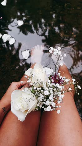 woman with flowers in a stream