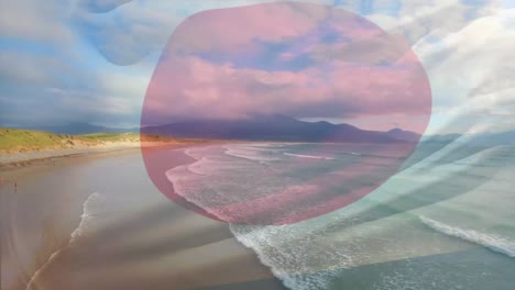 composición digital de la bandera de japón ondeando contra la vista aérea de las olas en el mar