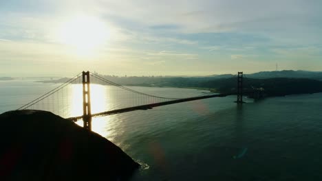 stunning sunrise view over golden gate bridge, reflecting golden hues on water