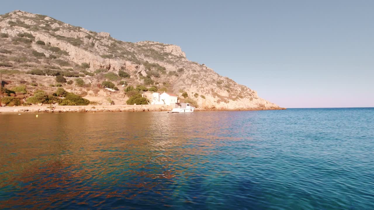 Calm Blue Waters Along the Shoreline of Greece's Landscape with Blue Skies in the Background