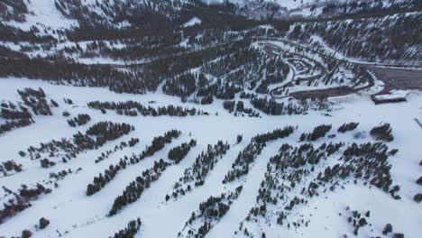 Aerial-view-over-snowy-alpine-forest-mt-rose-ski-resort-in-Lake-Tahoe,-USA,-showing-ski-trails