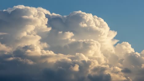 a captivating display of majestic clouds illuminated by soft evening light, showcasing their dynamic shapes and textures against a serene sky