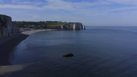 aerial speedramp effect shot forward approach to the natural arch of etretat france normandy on a sunny day
