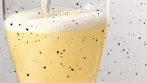 animation of confetti falling over champagne glass on white background