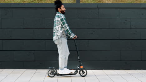 urban scene with man on scooter and brick wall