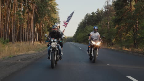 young bikers drive along the highway