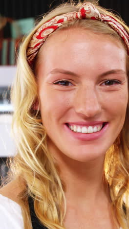 portrait of smiling waitress standing with arms crossed