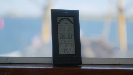 information chart that tells the time and temperature in digital and other data, located on a boat