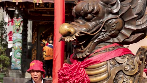 visitors admire dragon statue at hong kong temple