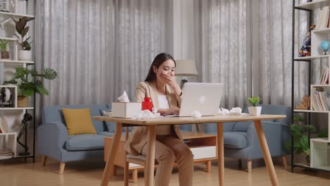 mujer de negocios asiática enferma tos mientras trabaja con una computadora portátil en la sala de estar en casa