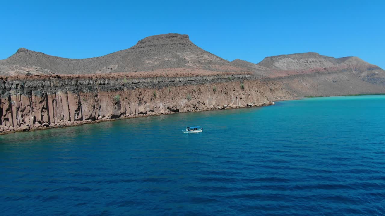 toma panorámica de vista aérea, un parque de botes turísticos al lado de la isla espiritu santo en baja sur, méxico, vista panorámica del mar azul profundo y la cordillera en el fondo