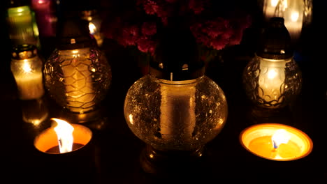 Grave-candle-lights-burning-at-night-on-cemetery-tomb