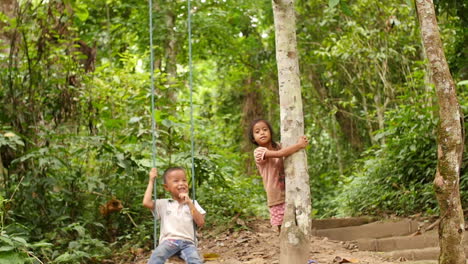 children swinging in a jungle