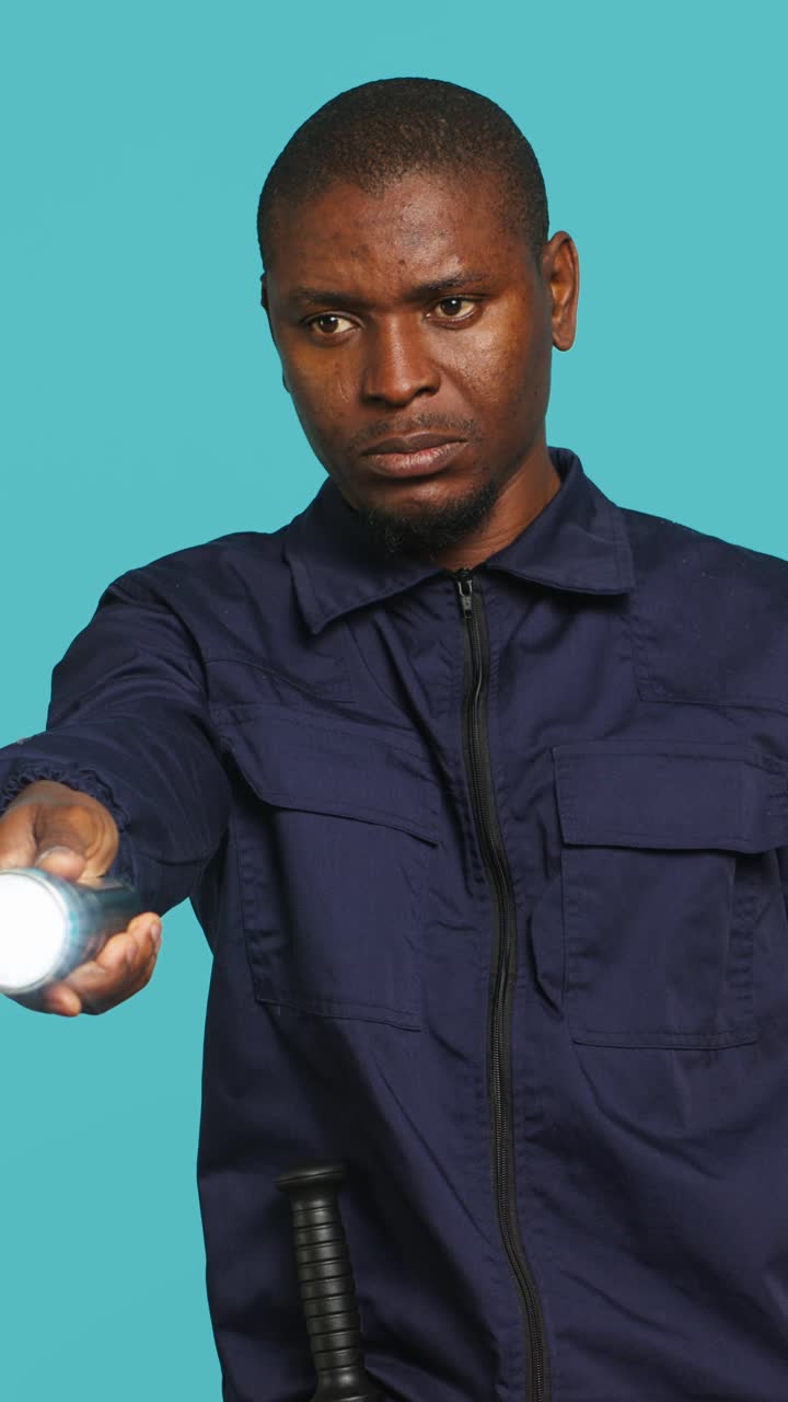 African American Man Turning On and Off a Flashlight