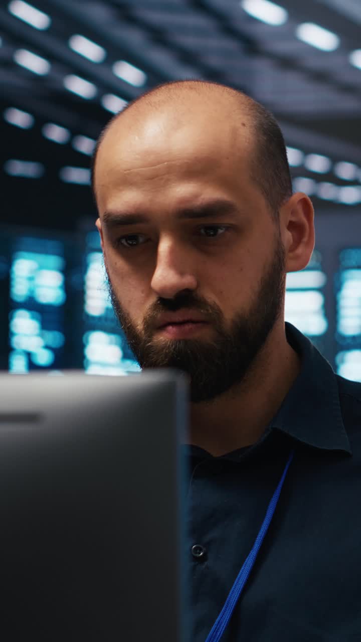 Focused IT Professional Working on Computer in Data Center