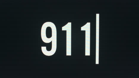 closeup of 911 being typed onto vintage computer monitor with blinking cursor